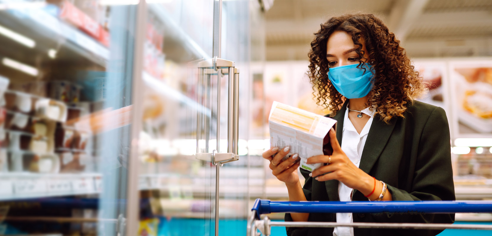 Mystery shopper standing in a frozen goods aisle looking at a product