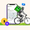 Uber Eats delivery person on bicycle next to an oversized phone with an order on the screen
