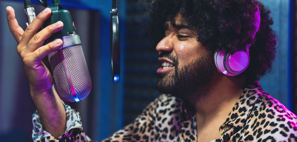 Voice actor in a studio speaking into a microphone