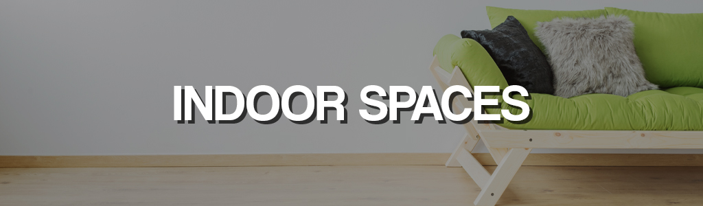 "Indoor spaces" against a darkened background showing a sofa with cushions
