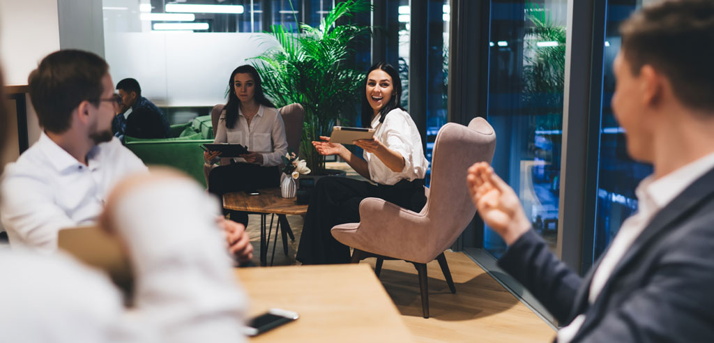 Several men and women sitting in an office setting, suggesting a meeting of the members of a tutoring association