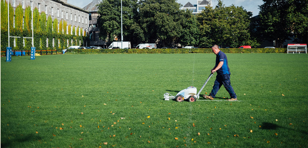 a lawn care professional is cutting the grass