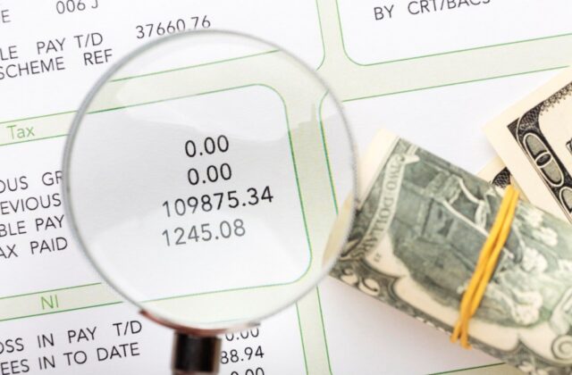 Magnifying glass viewing salary information.