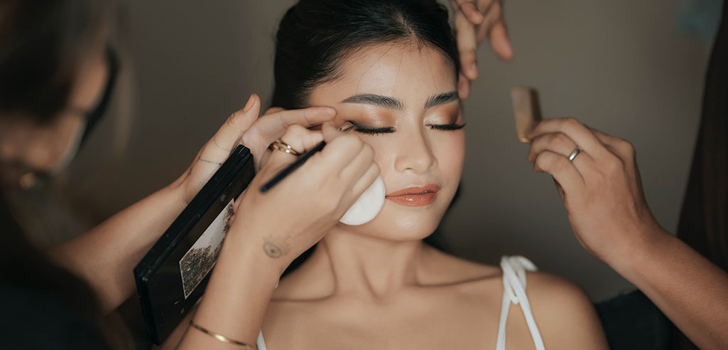 a makeup artist is doing her job