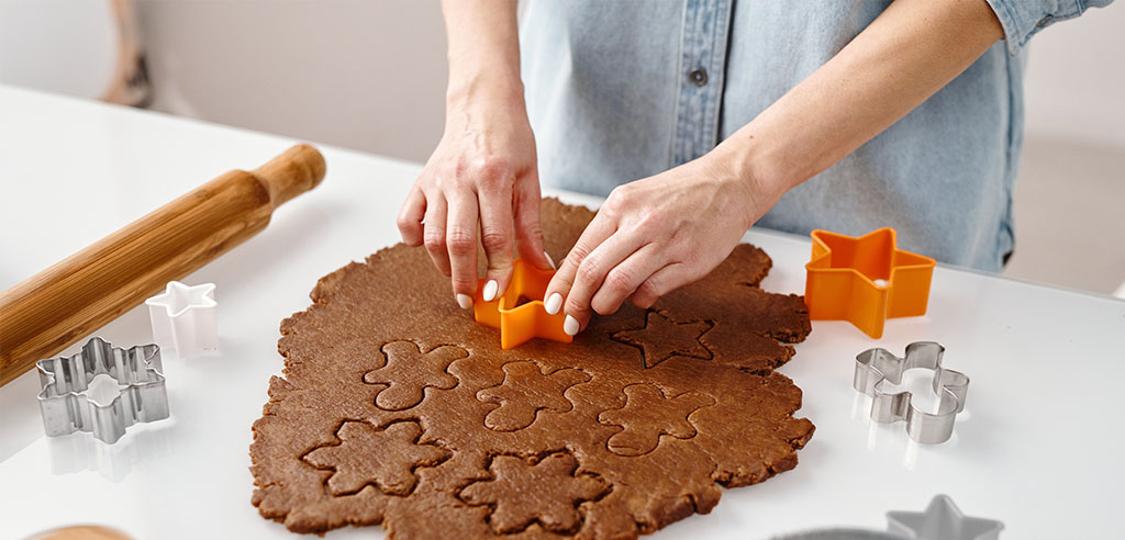 a home baker cuts cookie dough