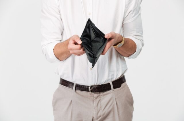 Man showing the inside of his empty wallet.