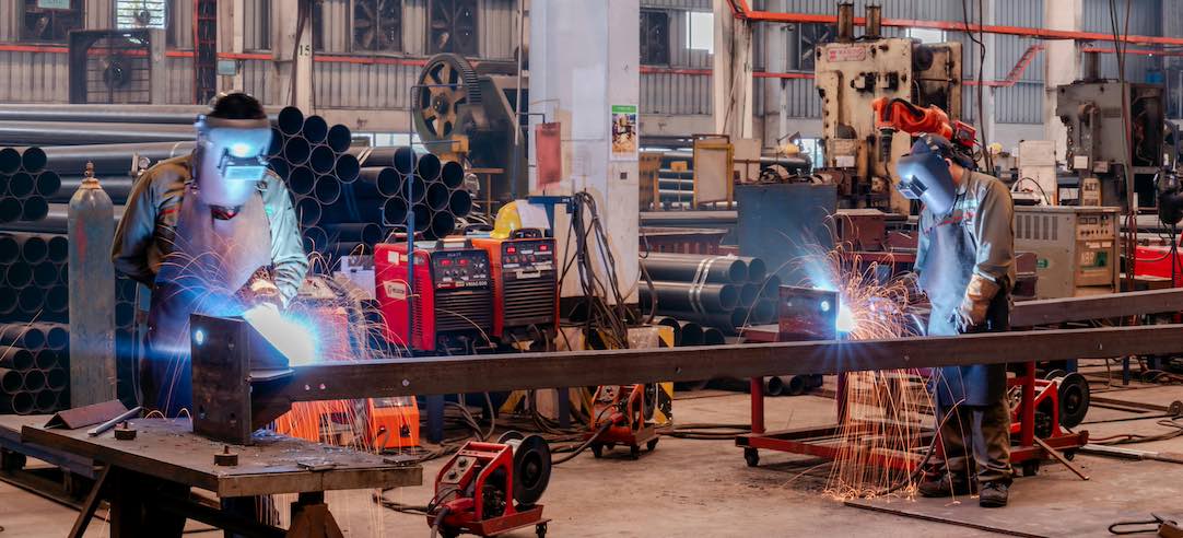 Two men working in a manufacturing warehouse.