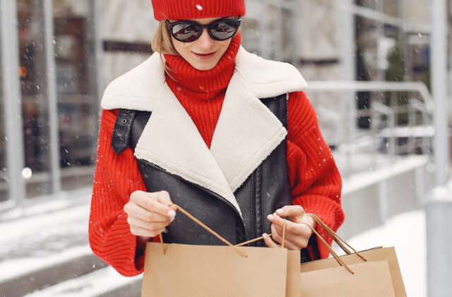 Mystery shopper carrying bags from a store.