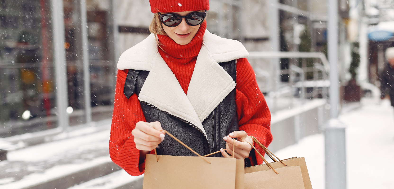 Mystery shopper standing outside a store holding two bags