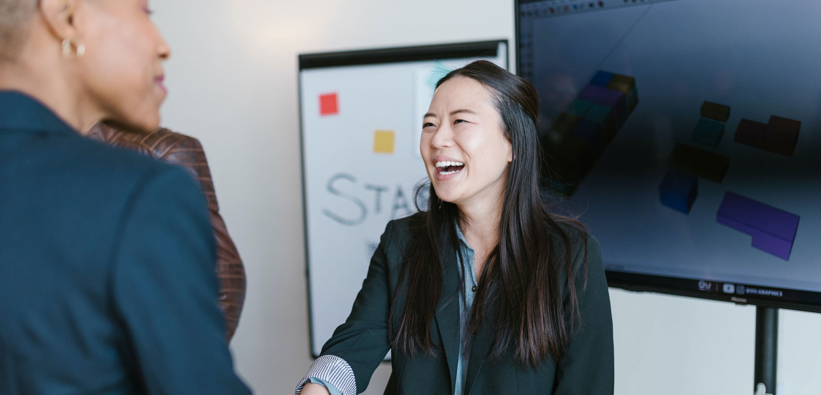 Freelance proofreader shaking hands with someone at a networking event