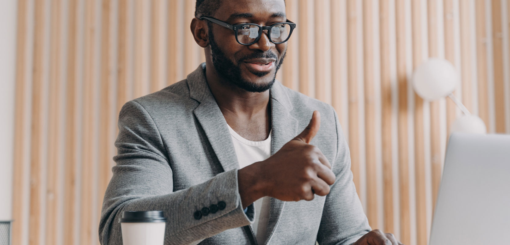 Freelance transcriptionist giving a thumbs up in a meeting