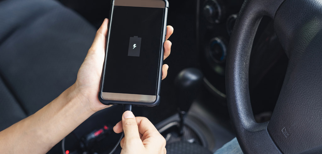 Uber passenger charging his phone with a cord provided as a free amenity