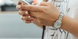 Close view of a woman's hands holding a smartphone.