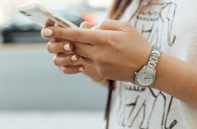 Close view of a woman's hands holding a smartphone.