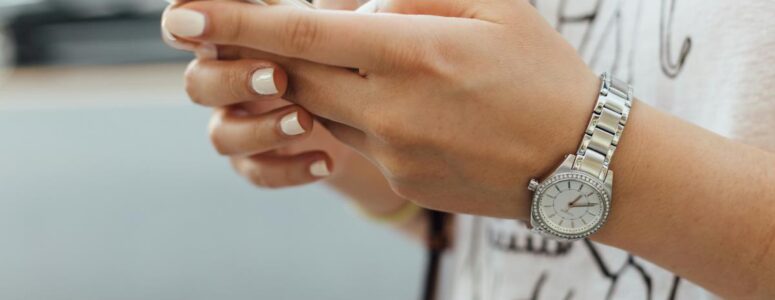 Close view of a woman's hands holding a smartphone.