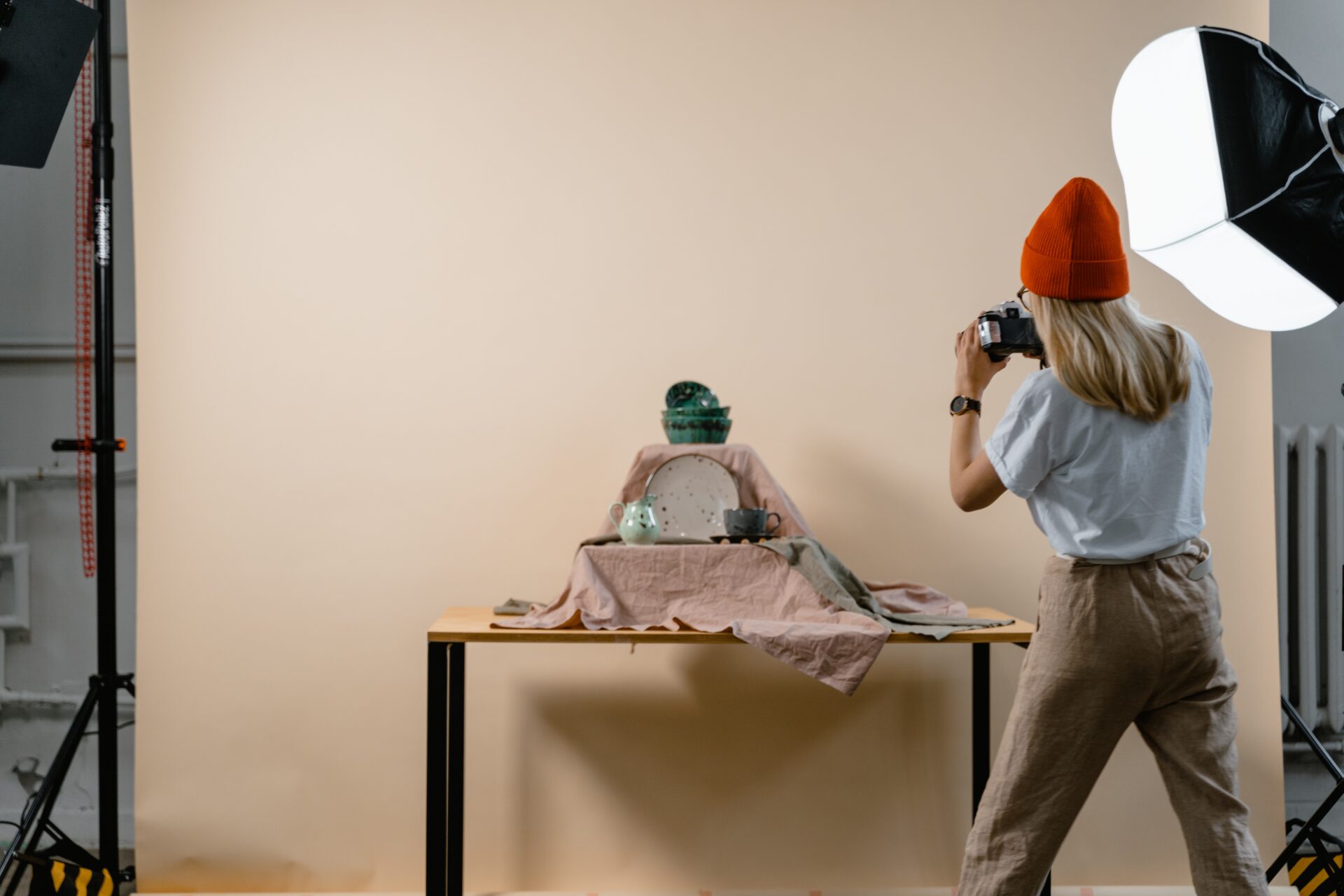 a woman is taking pictures of the items she's selling