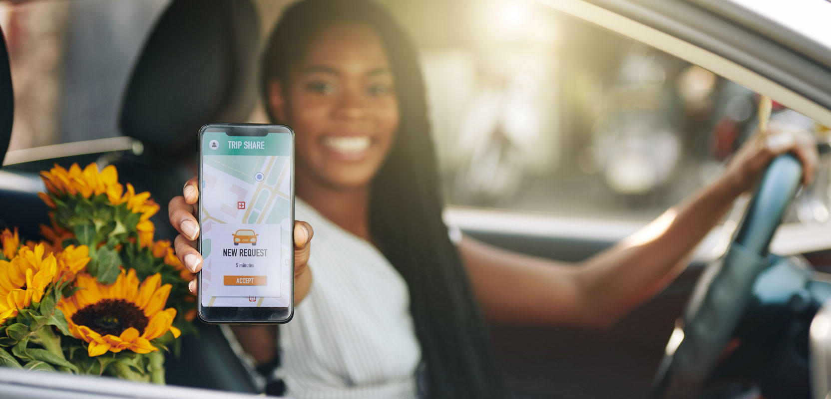Female Uber driver at the steering wheel of her car