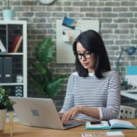 Pinterest virtual assistant working from home on her laptop.