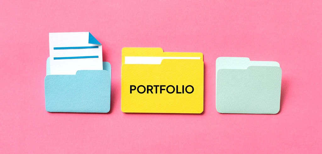 Three manila folders with a label reading Portfolio on the middle one