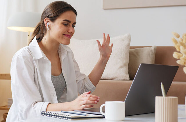 Mother sitting at her laptop earning money with her side hustle as a virtual assistant.