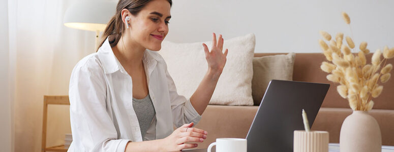 Mother sitting at her laptop earning money with her side hustle as a virtual assistant.