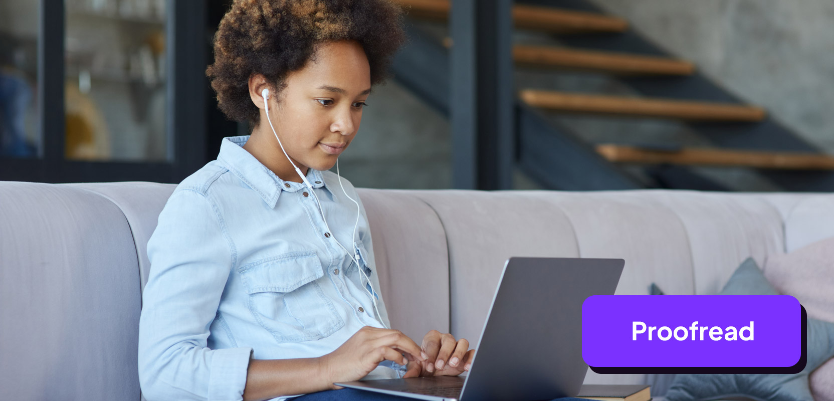 Teen sitting on a couch proofreading on her laptop for her freelance side hustle