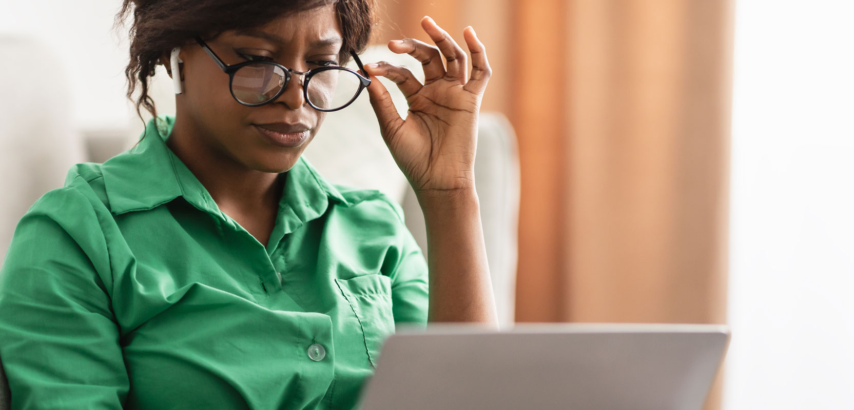 Introverted woman proofreading at her laptop