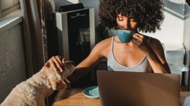 Freelance writer sitting at her laptop working on a project