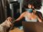 Freelance writer sitting at her laptop working on a project