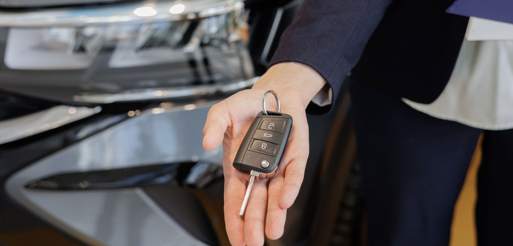 Car keys for rental car sitting in person's hand