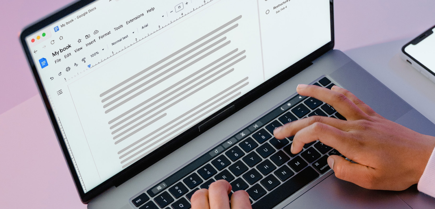 Closeup of someone writing their own book on a laptop for their freelance writing side hustle