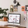 Remote work station for selling handmade items from home, featuring a desk, computer, and handmade cards pinned to the wall