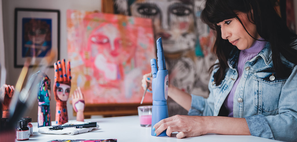 Woman sitting at home and painting wooden crafts to sell online 
