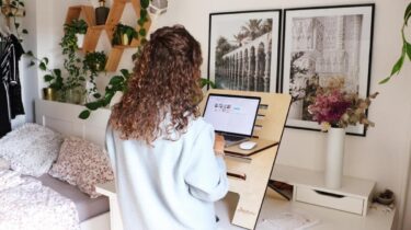 E-commerce seller sitting at her computer working on her online selling side hustle.