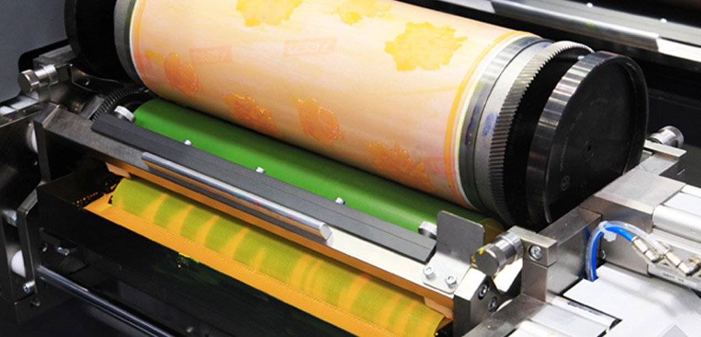 Colorful patterned sheets in a printer representing selling printables as a side hustle