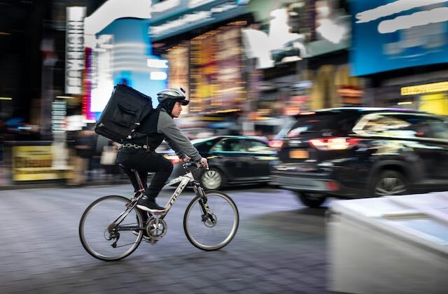 Bicycle courier delivering food for their side hustle.