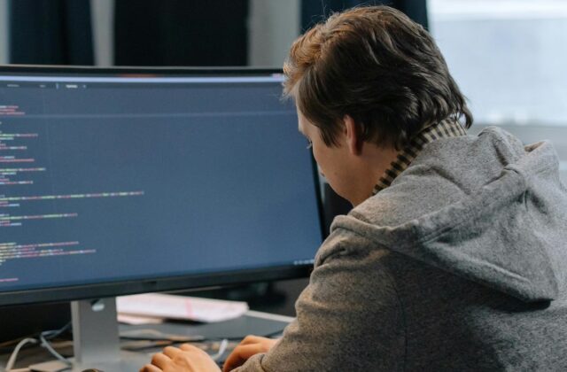 Software engineer writing code on a computer.