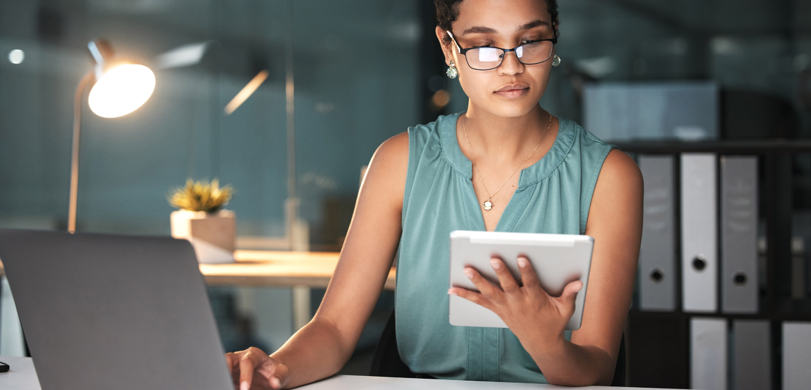 Freelance proofreader looking at her tablet and evaluating her portfolio 