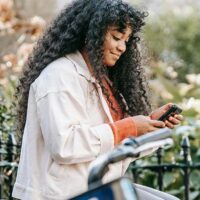 Woman taking a survey on her phone that offers an instant payout.