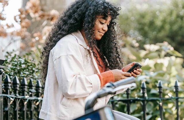 Woman taking a survey on her phone that offers an instant payout.