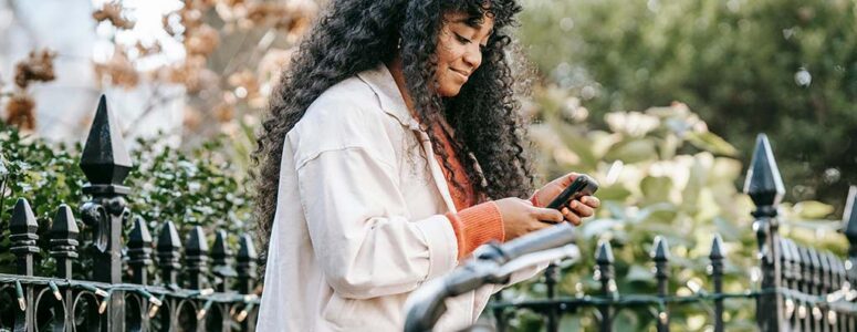 Woman taking a survey on her phone that offers an instant payout.