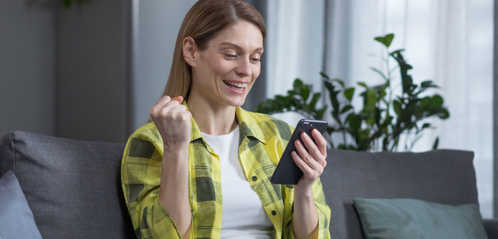 Woman sitting on couch taking an online survey for money