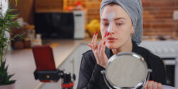 Woman testing cosmetic products at home.