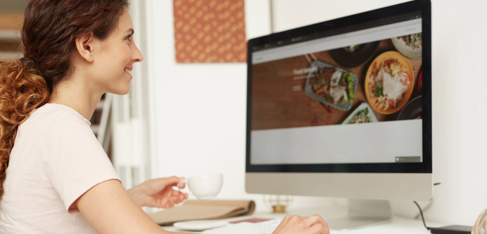 Freelancer testing a website on her computer at home for her side hustle