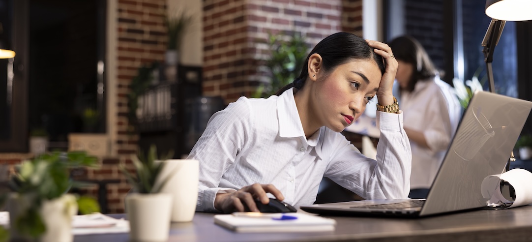 A tired woman working late at the office.