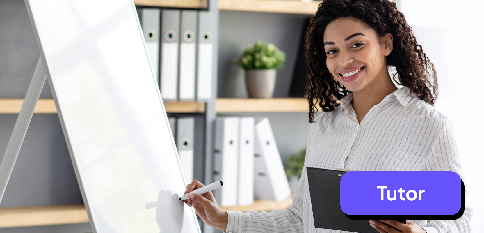 Female nurse standing at a whiteboard explaining something for a tutoring session