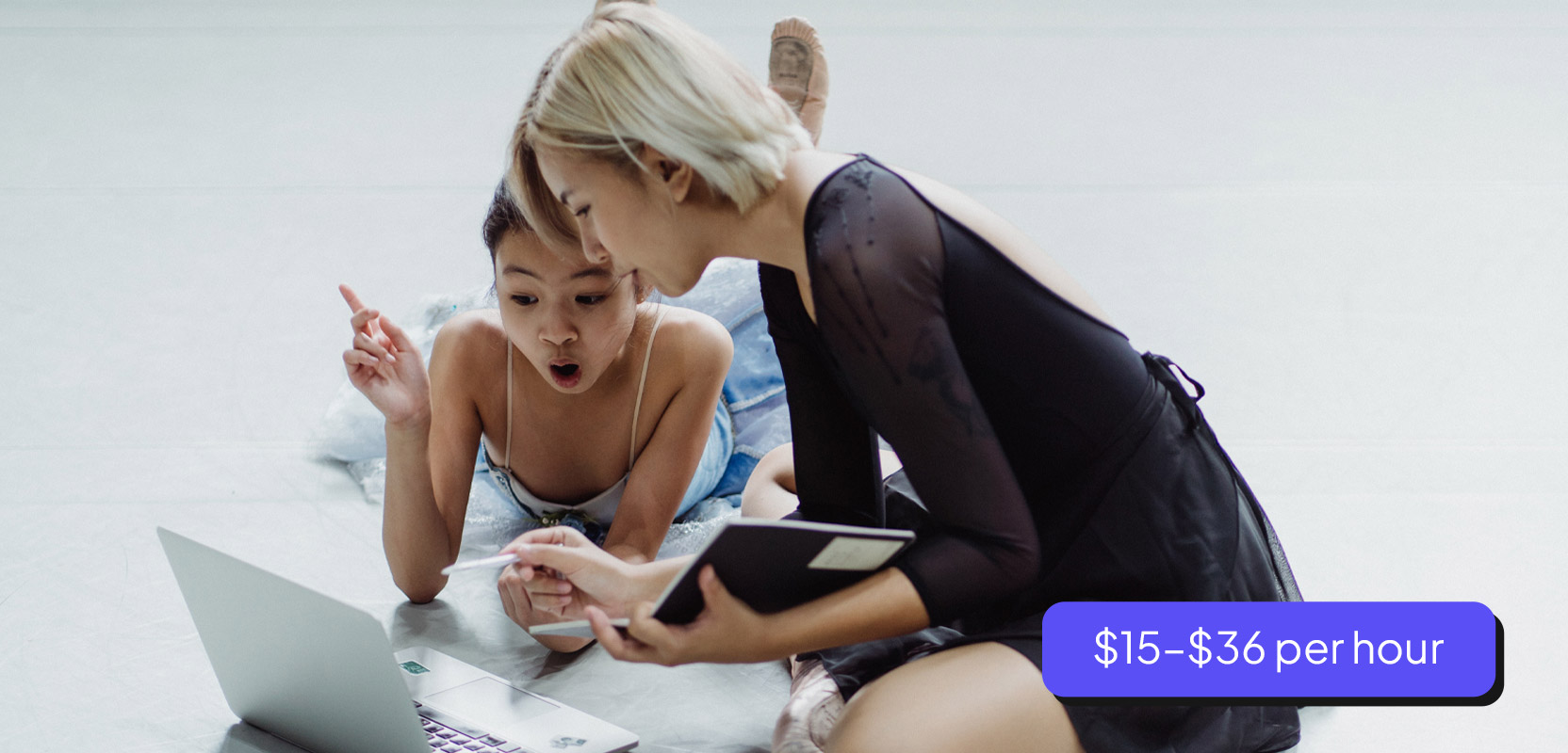 Tutor and student working at a laptop