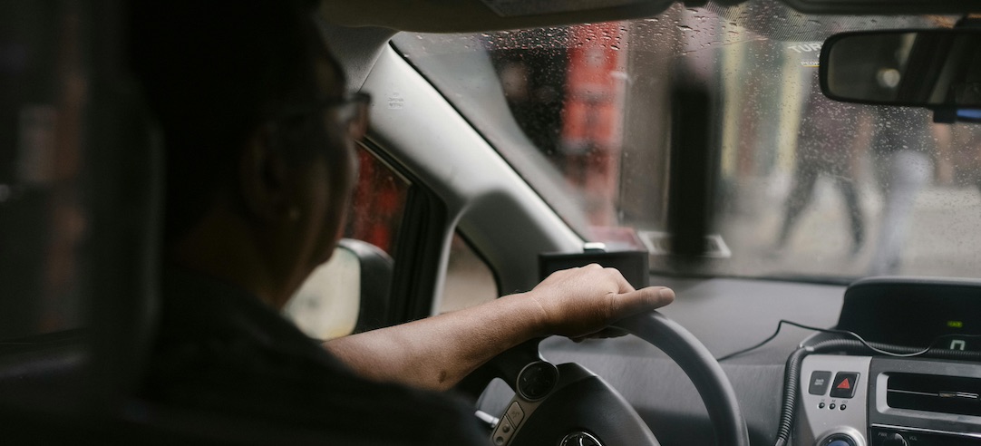 Photo of a rideshare driver driving their car.