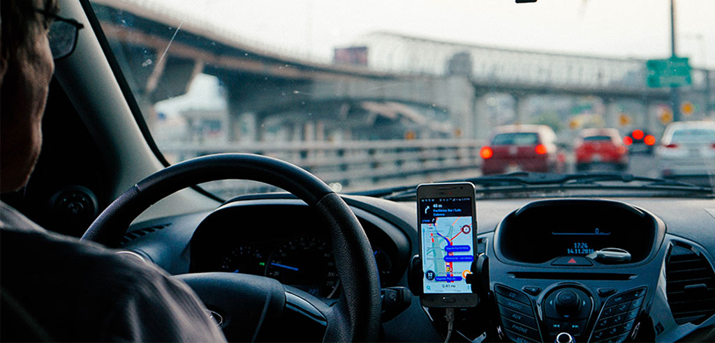 An uber driver is driving his car