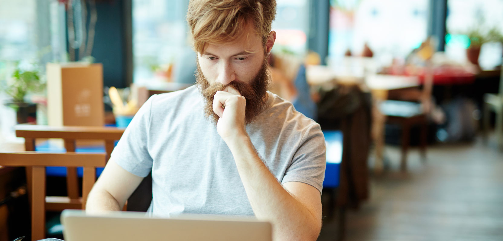 Solo web tester sitting at his laptop and working